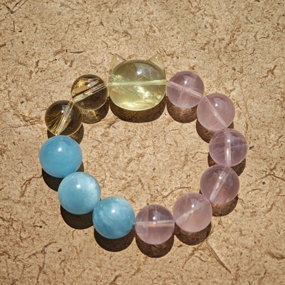 This is a Rose Quartz Bracelet with Aquamarine, Citrine crystal and cat charm.