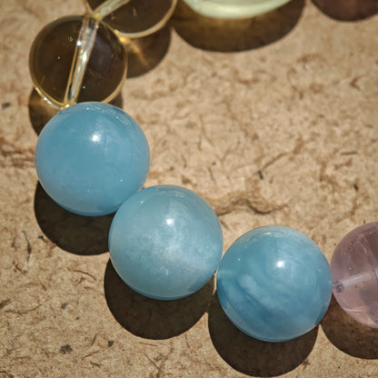 This is a Rose Quartz Bracelet with Aquamarine, Citrine crystal and cat charm.