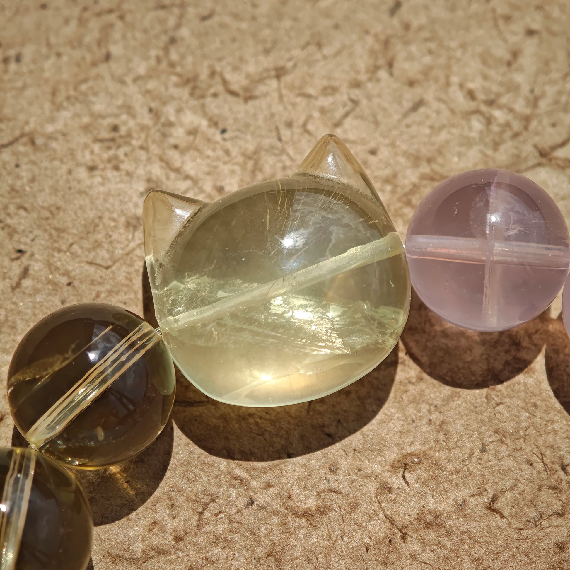 This is a Rose Quartz Bracelet with Aquamarine, Citrine crystal and cat charm.