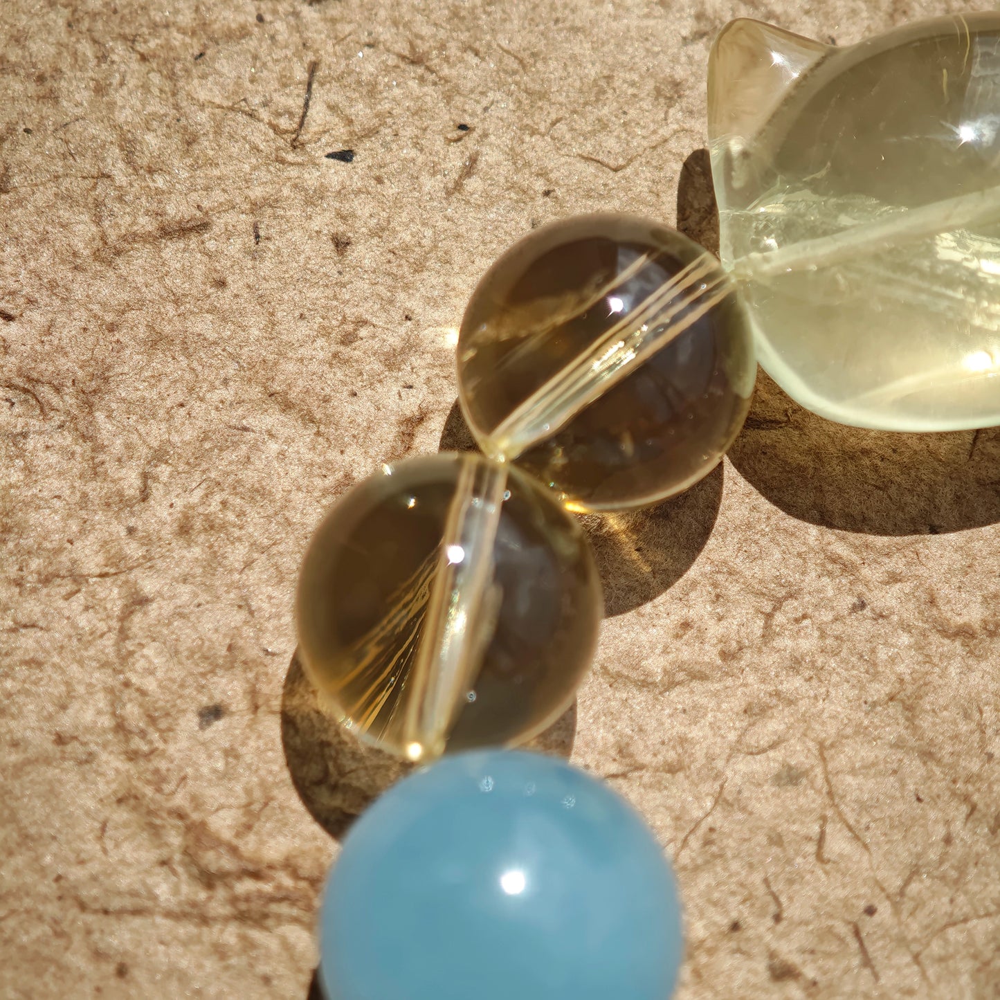 This is a Rose Quartz Bracelet with Aquamarine, Citrine crystal and cat charm.