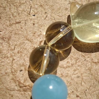 This is a Rose Quartz Bracelet with Aquamarine, Citrine crystal and cat charm.