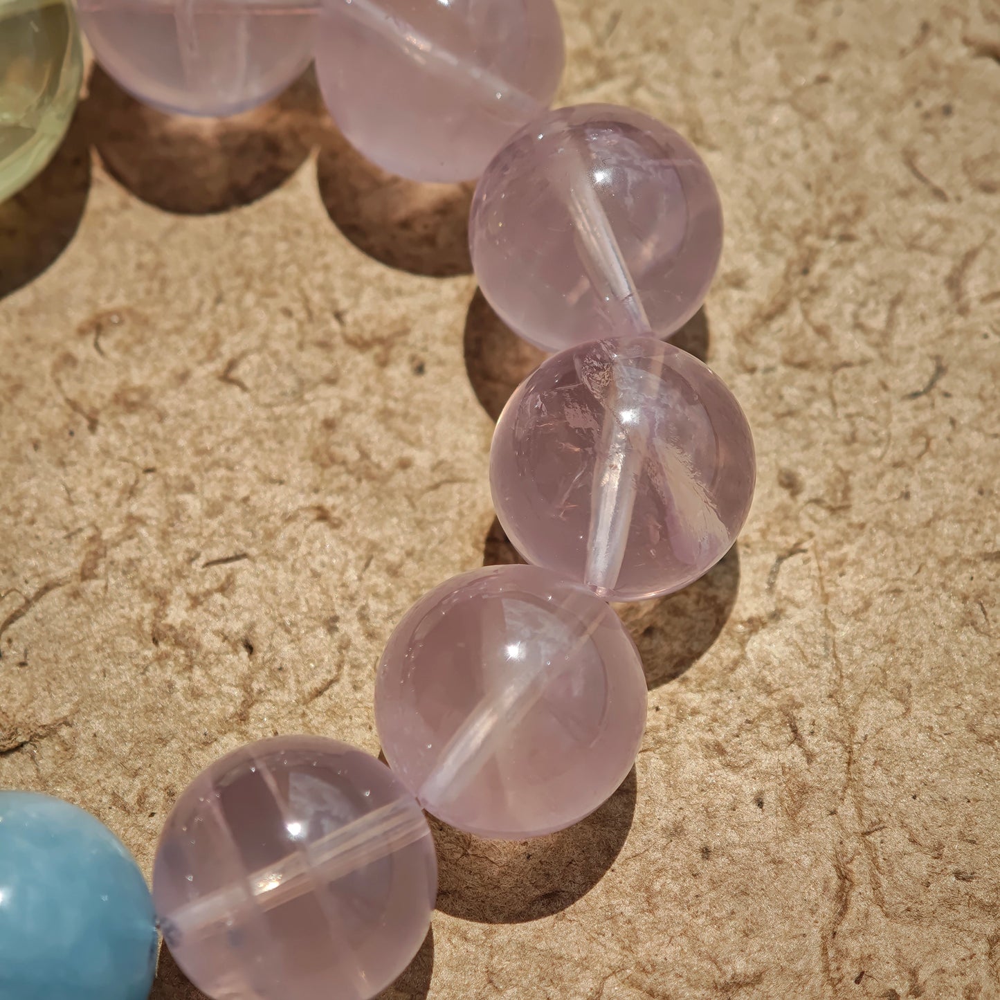 This is a Rose Quartz Bracelet with Aquamarine, Citrine crystal and cat charm.