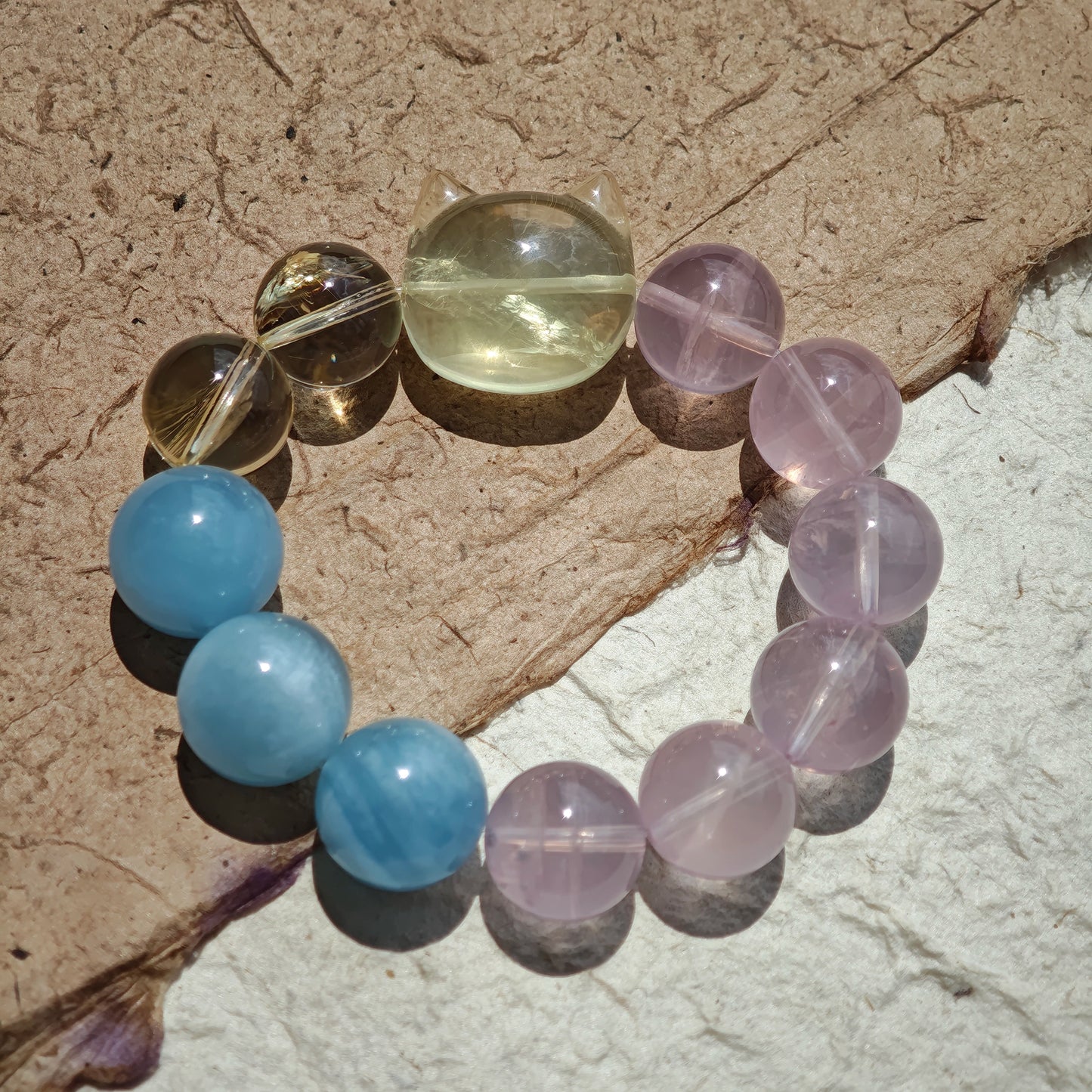 This is a Rose Quartz Bracelet with Aquamarine, Citrine crystal and cat charm.