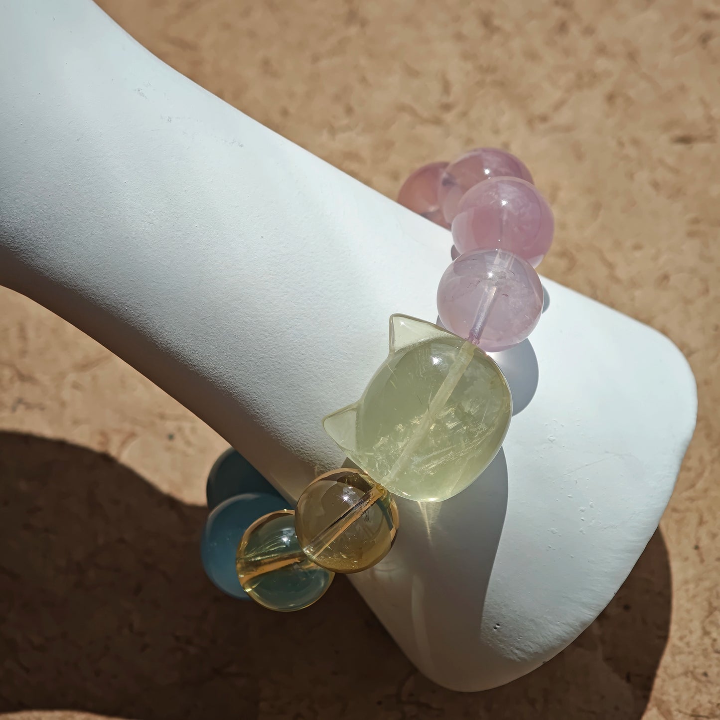 This is a Rose Quartz Bracelet with Aquamarine, Citrine crystal and cat charm.