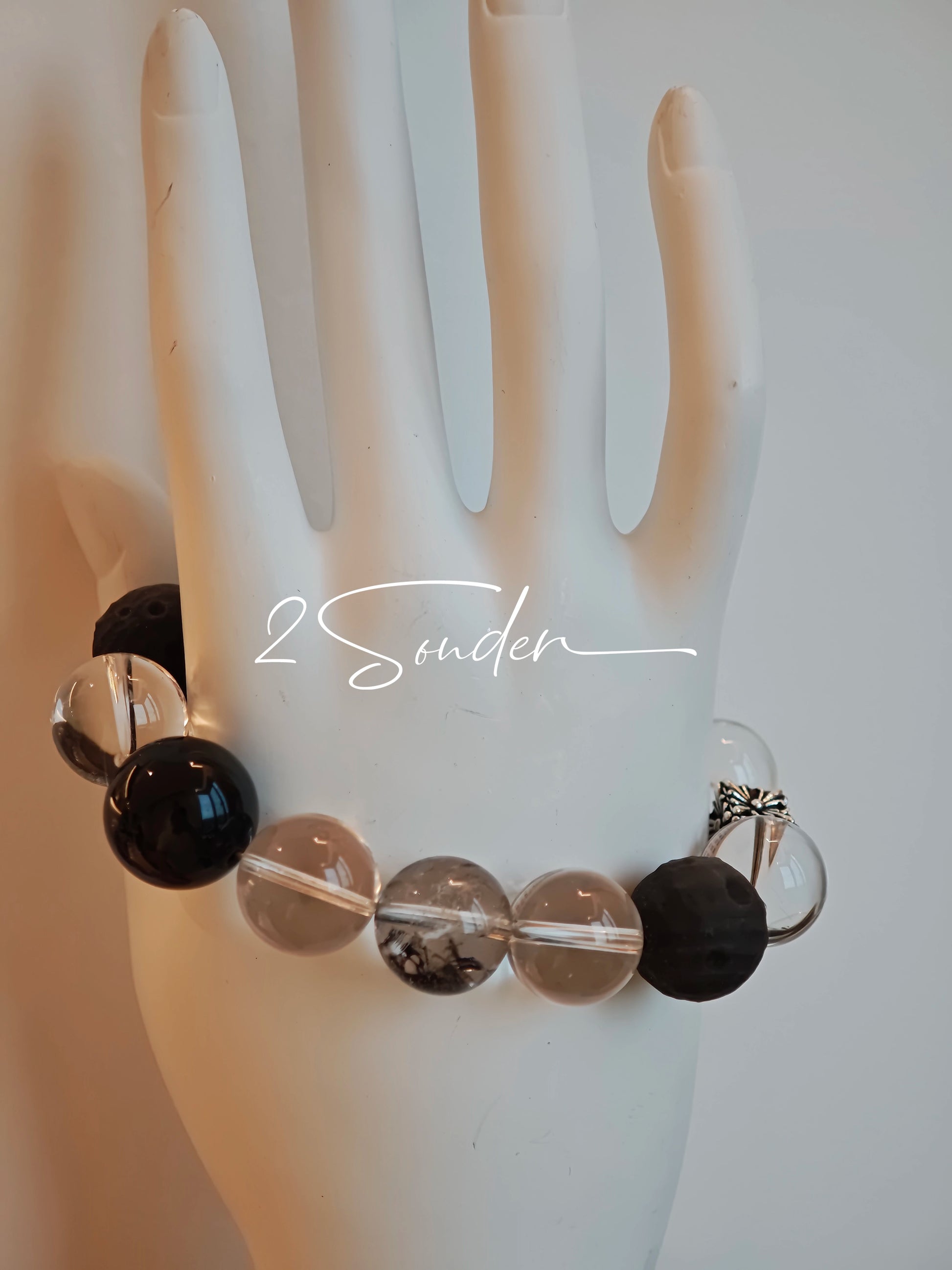 This is a bracelet consists of silver sheen obsidian, clear quartz, herkimer diamonds, meteorite and edgy accents.