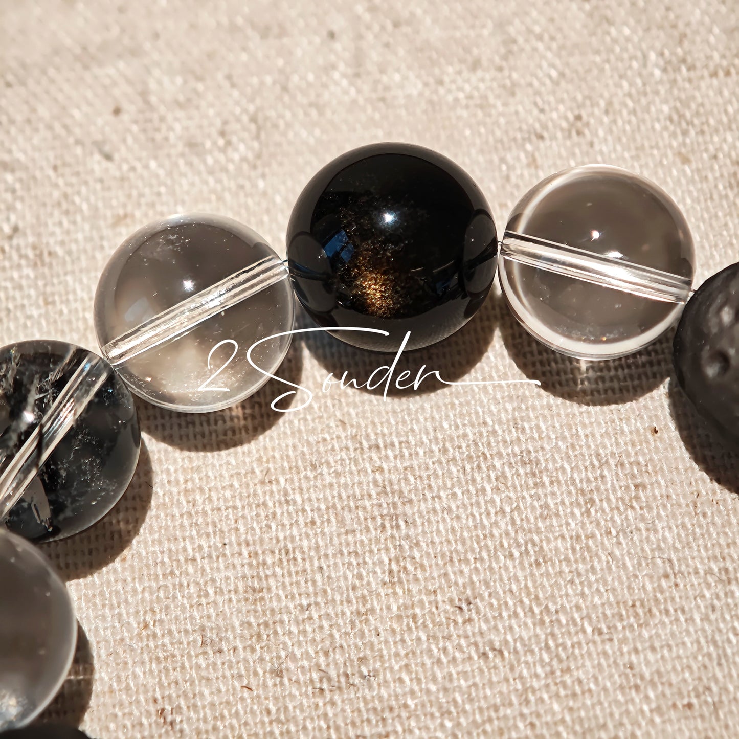 This is a bracelet consists of silver sheen obsidian, clear quartz, herkimer diamonds, meteorite and edgy accents.