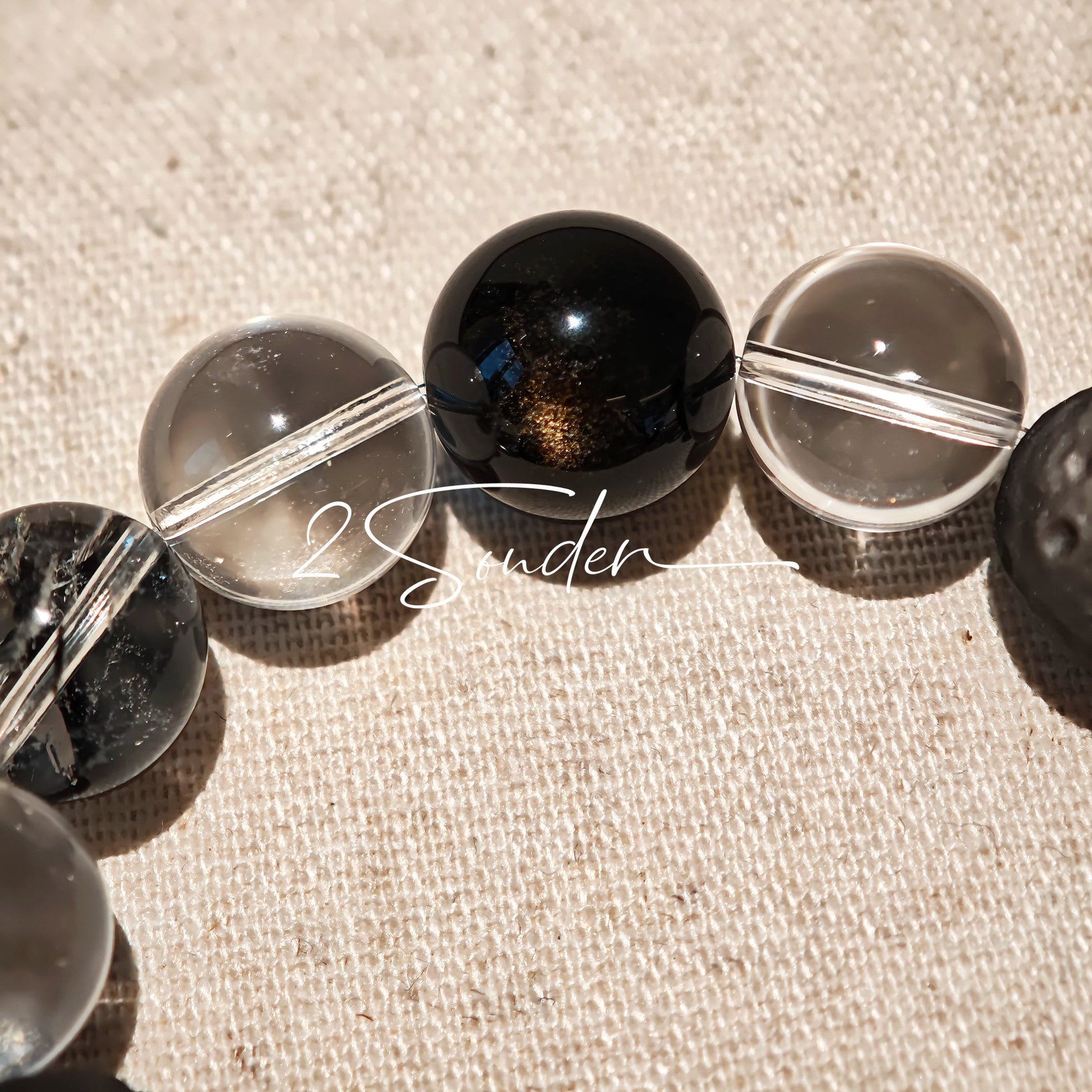 This is a bracelet consists of silver sheen obsidian, clear quartz, herkimer diamonds, meteorite and edgy accents.