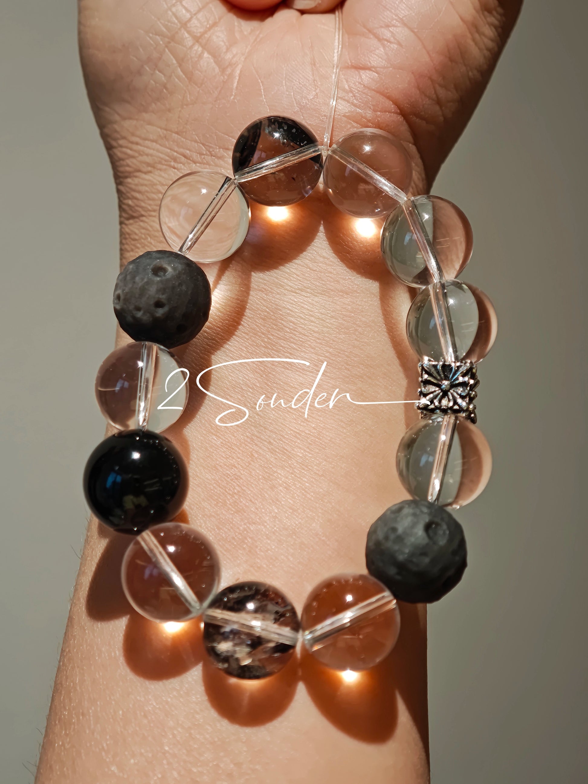 This is a bracelet consists of silver sheen obsidian, clear quartz, herkimer diamonds, meteorite and edgy accents.