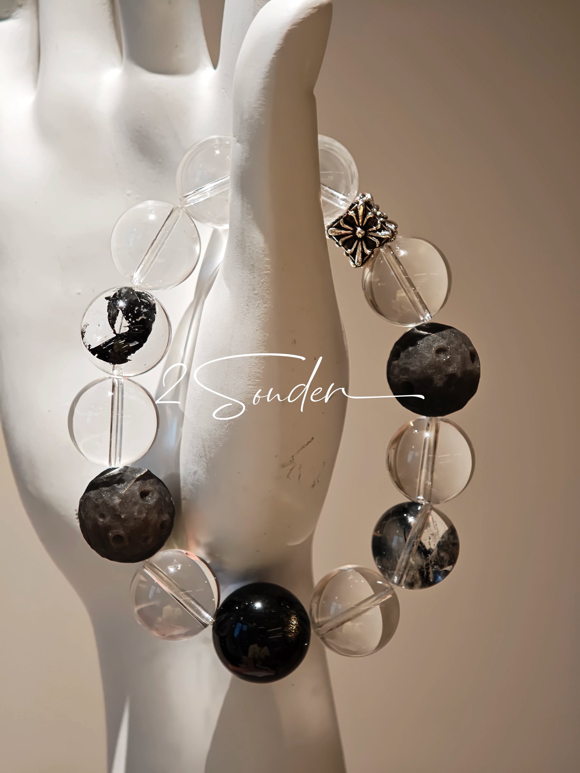 This is a bracelet consists of silver sheen obsidian, clear quartz, herkimer diamonds, meteorite and edgy accents.