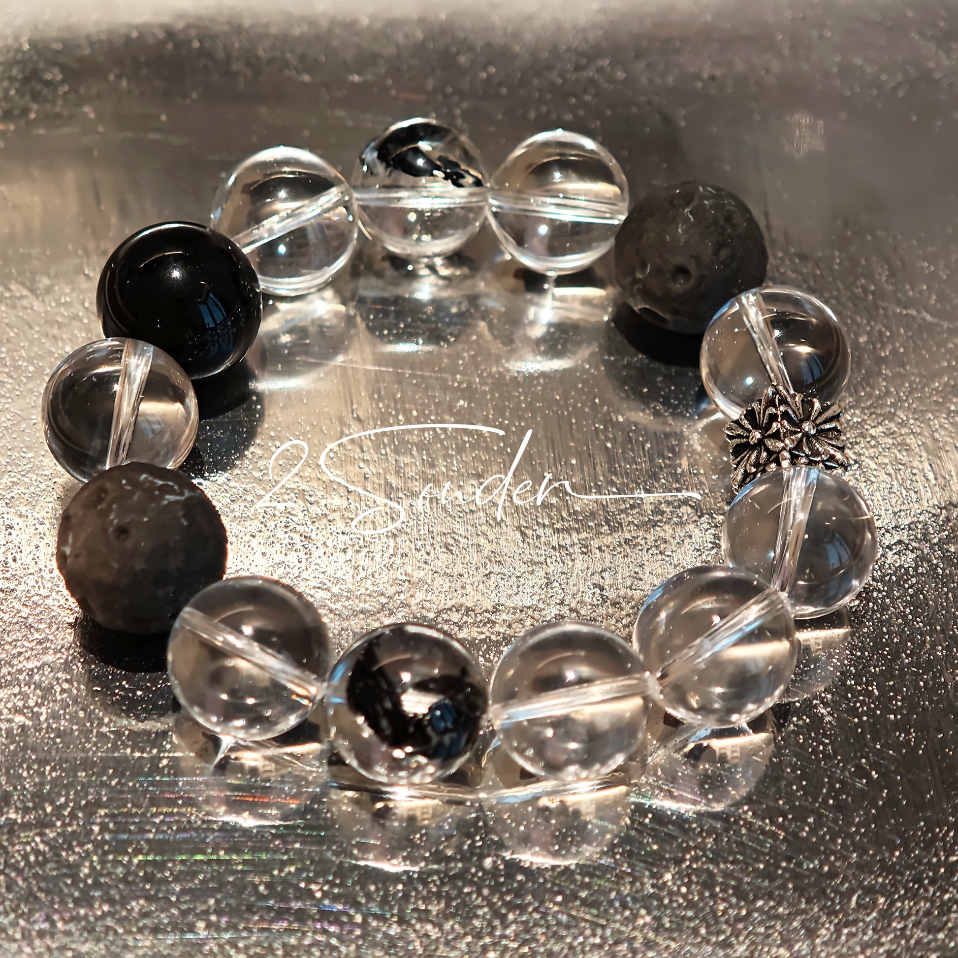 This is a bracelet consists of silver sheen obsidian, clear quartz, herkimer diamonds, meteorite and edgy accents.