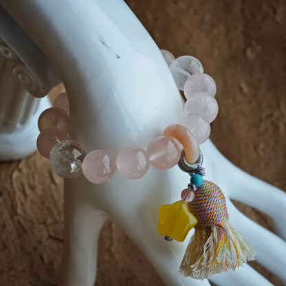 Luminous pink and translucent blue unite, while an amber star, agate slider, and silky fringe add playful bohemian grace.