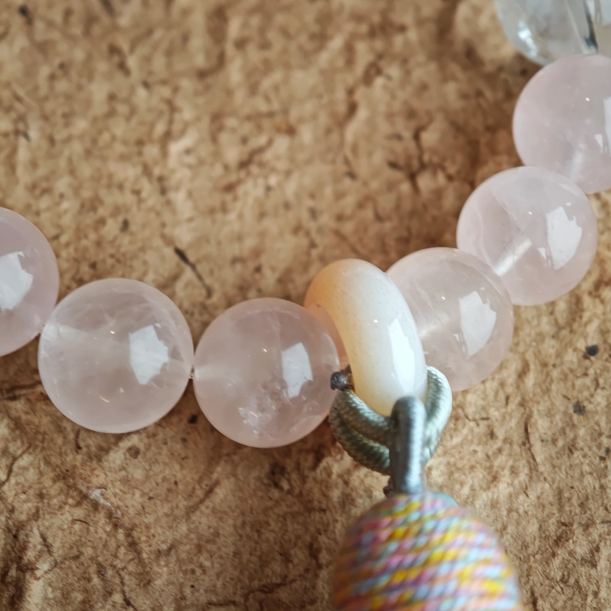 Peachy crystals braid with sky-blue shards, then an amber star, agate traveler, and wispy tassel complete the wanderer’s look.