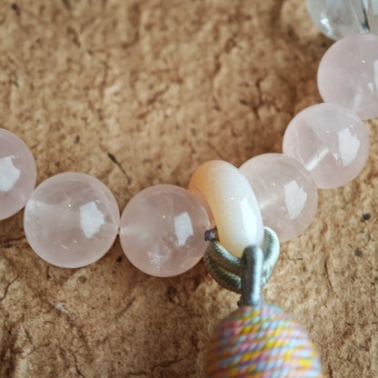 Peachy crystals braid with sky-blue shards, then an amber star, agate traveler, and wispy tassel complete the wanderer’s look.