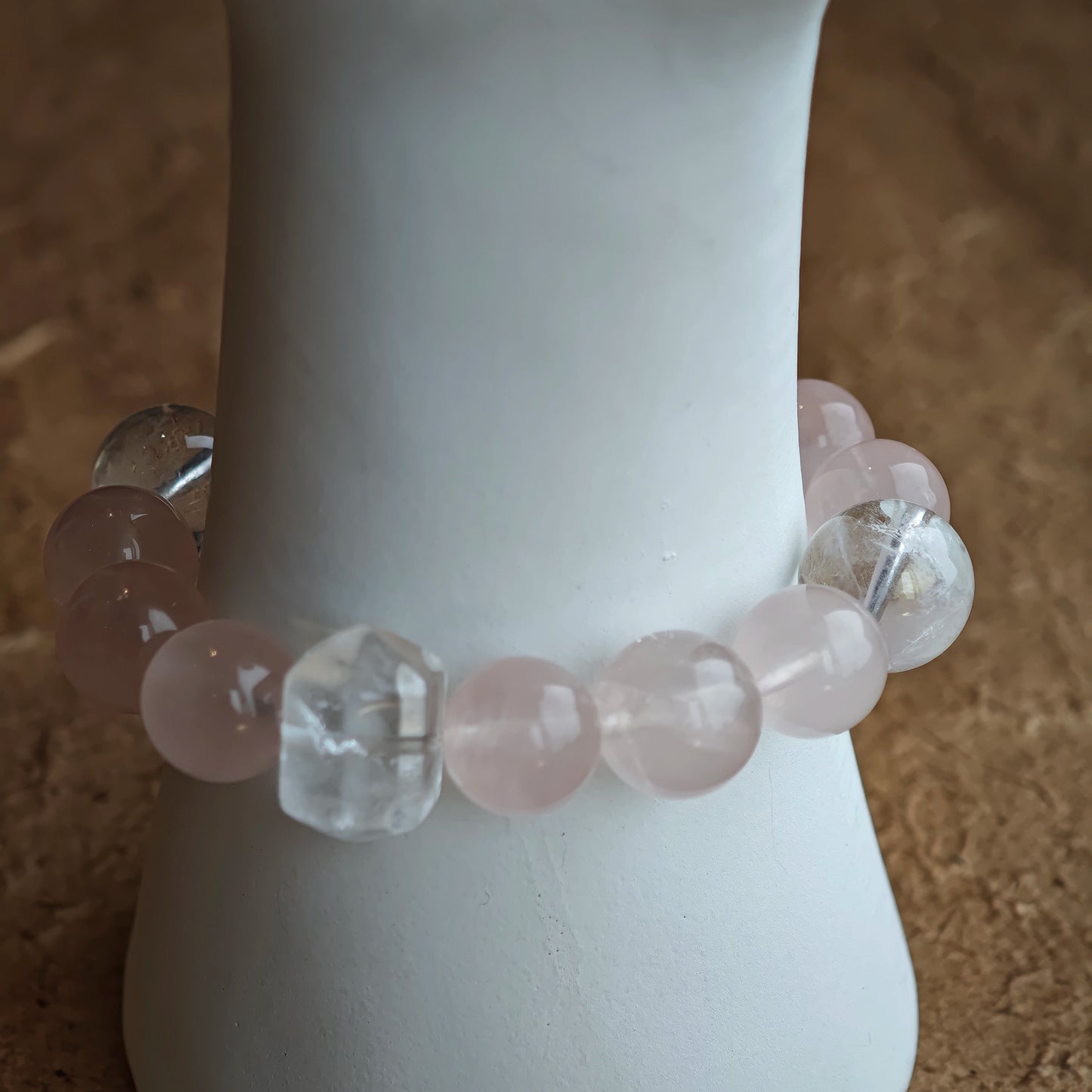 Roseate gems lock arms with sapphire threads, while an amber star, agate bead, and delicate fringe dance at the edges.