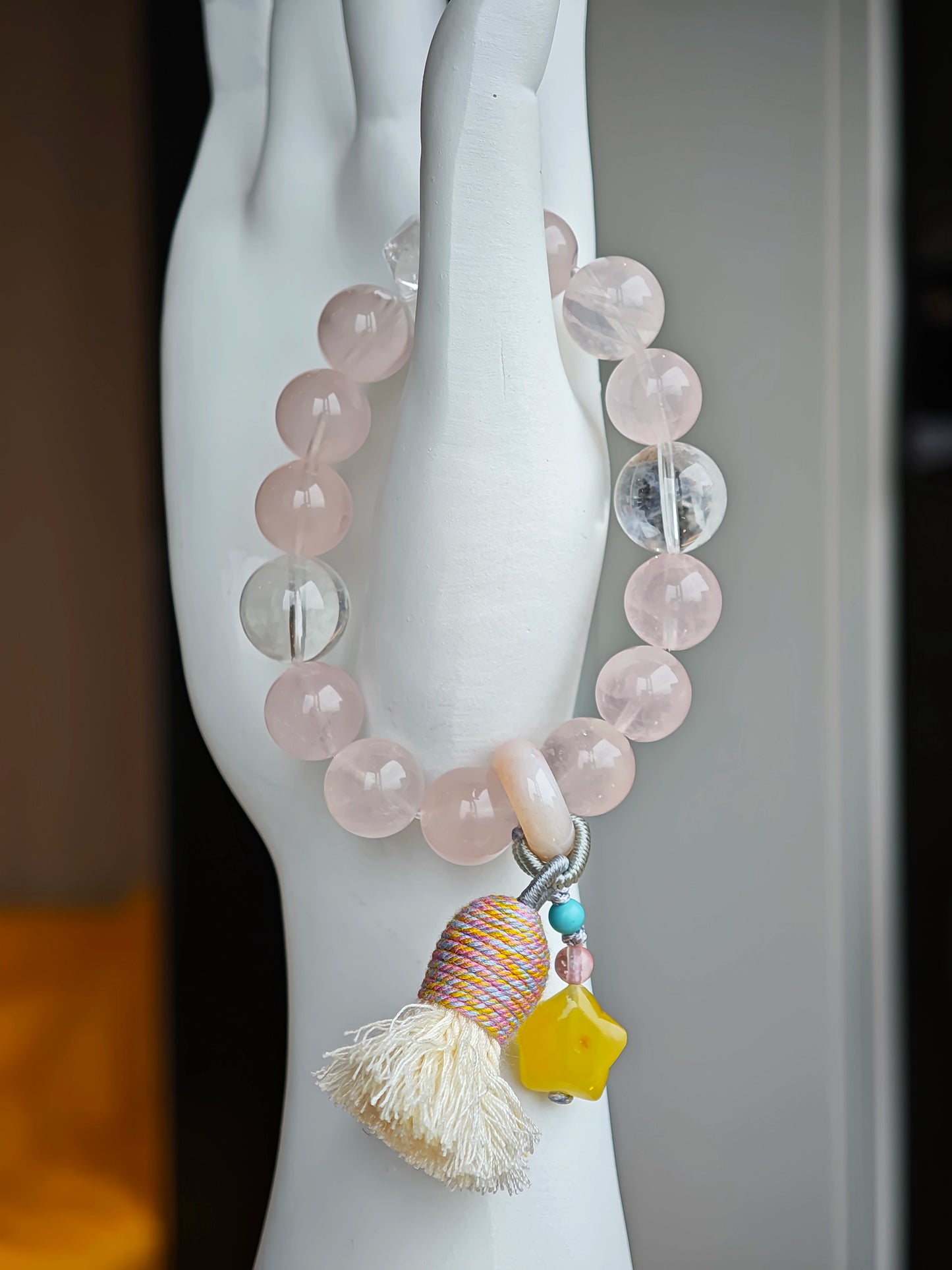 Gentle pink pulses beside celestial blue, and an amber star, agate bead, and airy tassel lend free-spirited sparkle.