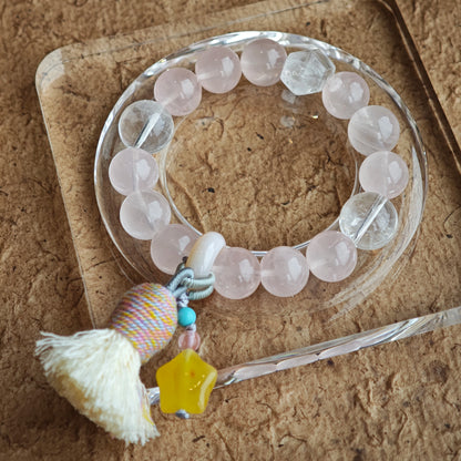 Blush-pink stones dance with icy blue needles, then amber starlight, a roaming agate bead, and a graceful fringe join the gypsy tale.