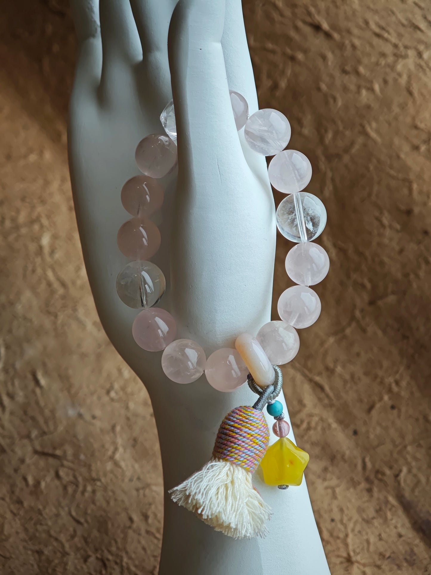 Pink serenity entwines with blue mystery, and an amber star, wandering agate, and feather-light tassel give it wanderlust soul.