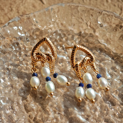 This is a pair of earrings that made of Lapis Lazuli, pearl and sterling silver. It's vintage and elegant.