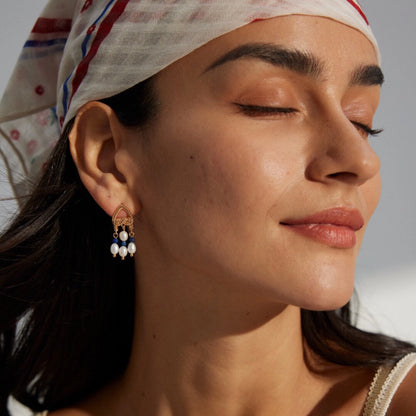 This is a pair of earrings that made of Lapis Lazuli, pearl and sterling silver. It's vintage and elegant.