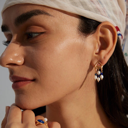 This is a pair of earrings that made of Lapis Lazuli, pearl and sterling silver. It's vintage and elegant.