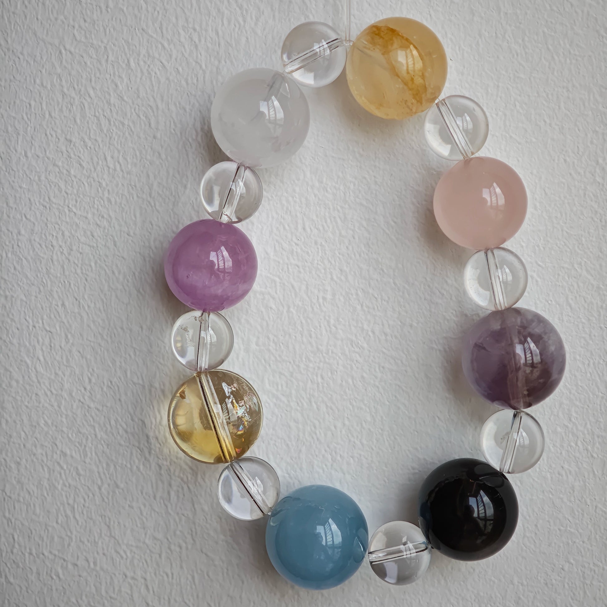 This is a multi-gemstone bracelets consists of Aquamarine, Amethyst, Citrine and White Phantom, etc.