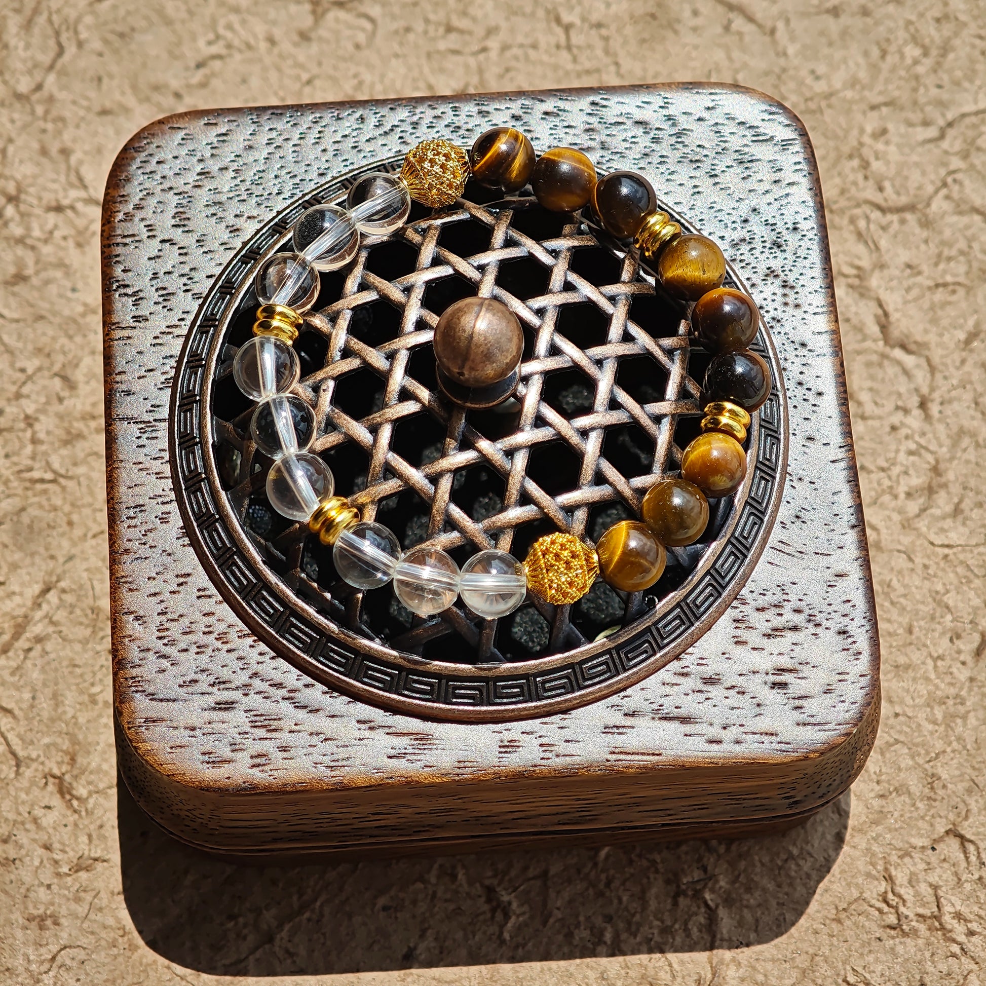 This is a tiger's eye bracelet with clear quartz and gold-plated copper spacer.
