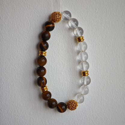 This is a tiger's eye bracelet with clear quartz and gold-plated copper spacer.