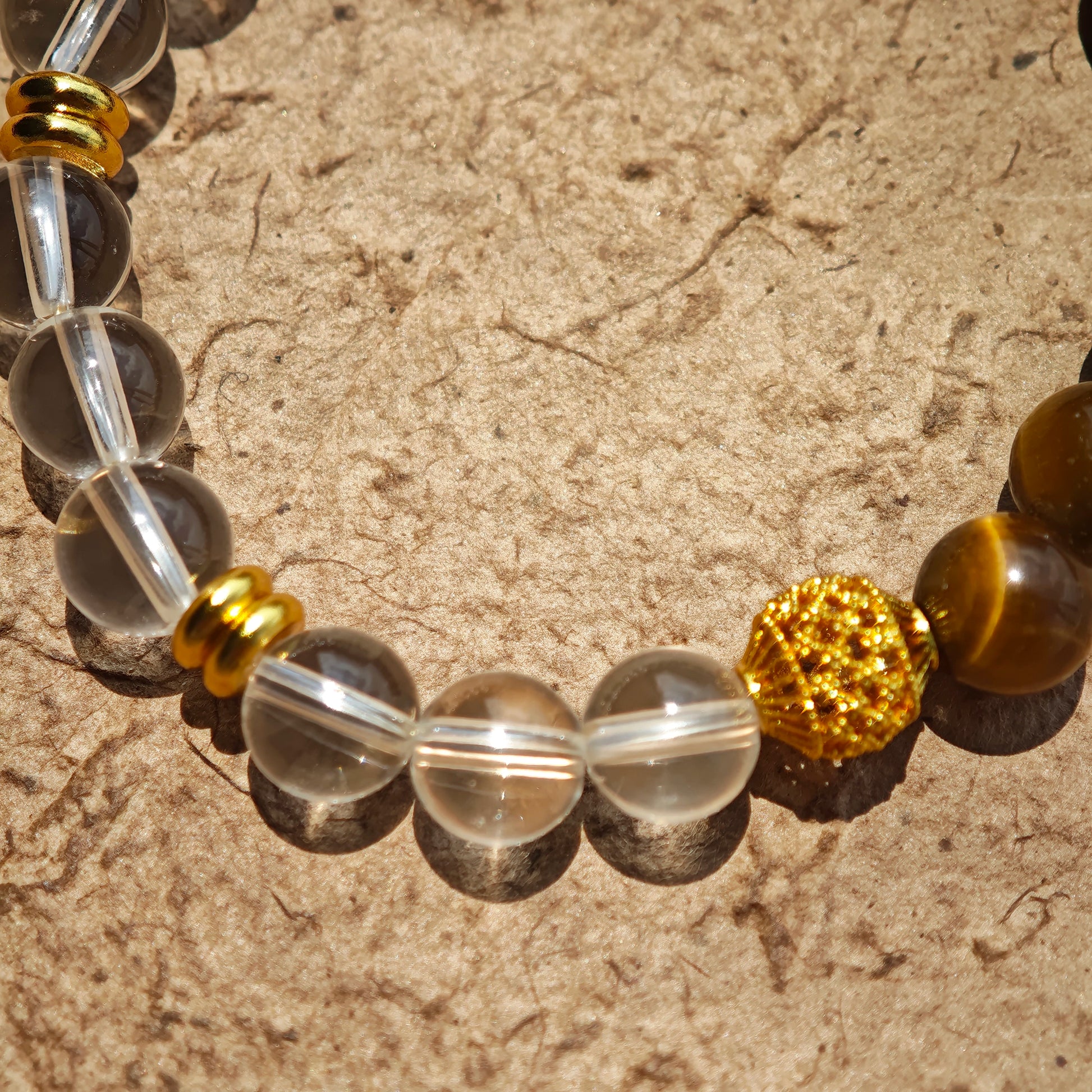 This is a tiger's eye bracelet with clear quartz and gold-plated copper spacer.