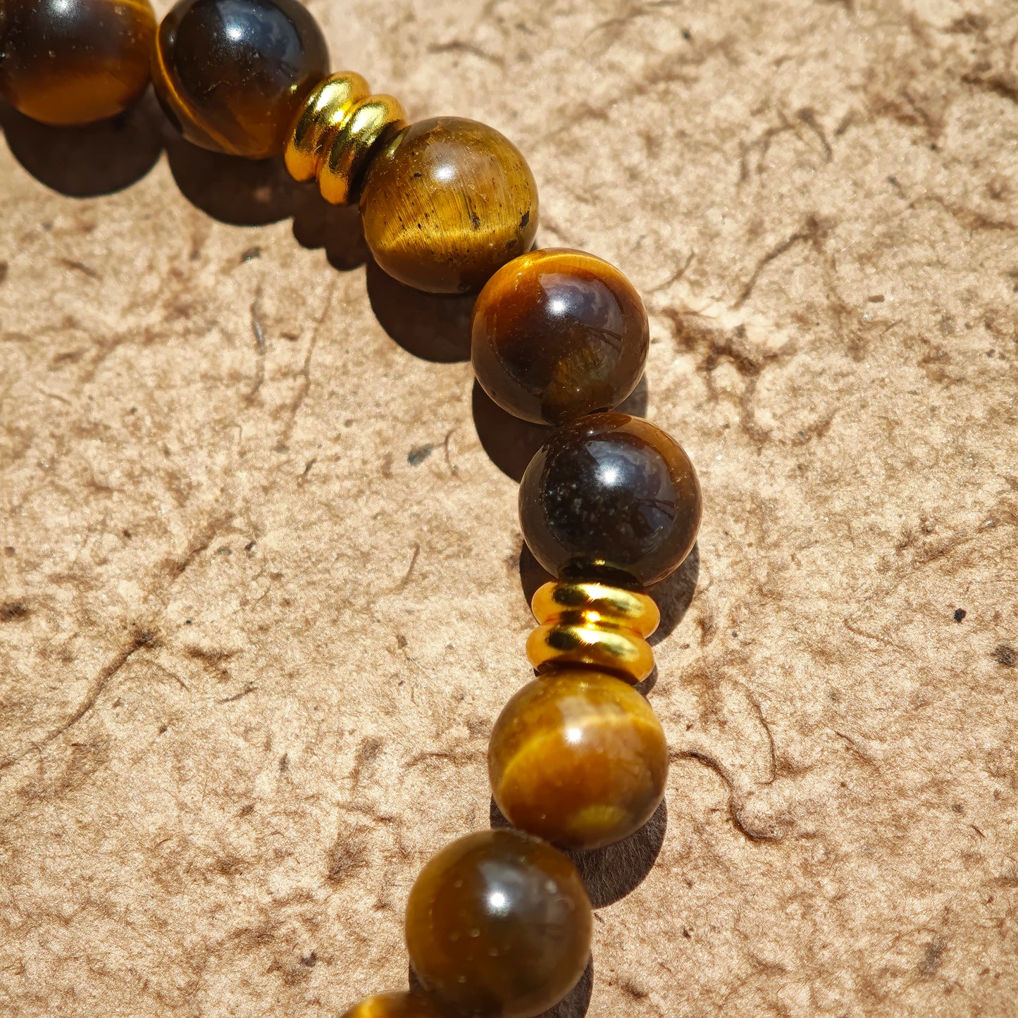 This is a tiger's eye bracelet with clear quartz and gold-plated copper spacer.