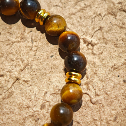 This is a tiger's eye bracelet with clear quartz and gold-plated copper spacer.