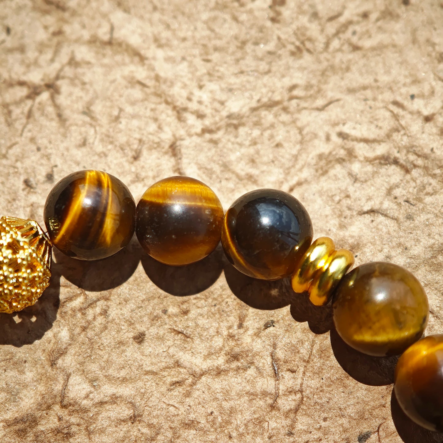 This is a tiger's eye bracelet with clear quartz and gold-plated copper spacer.