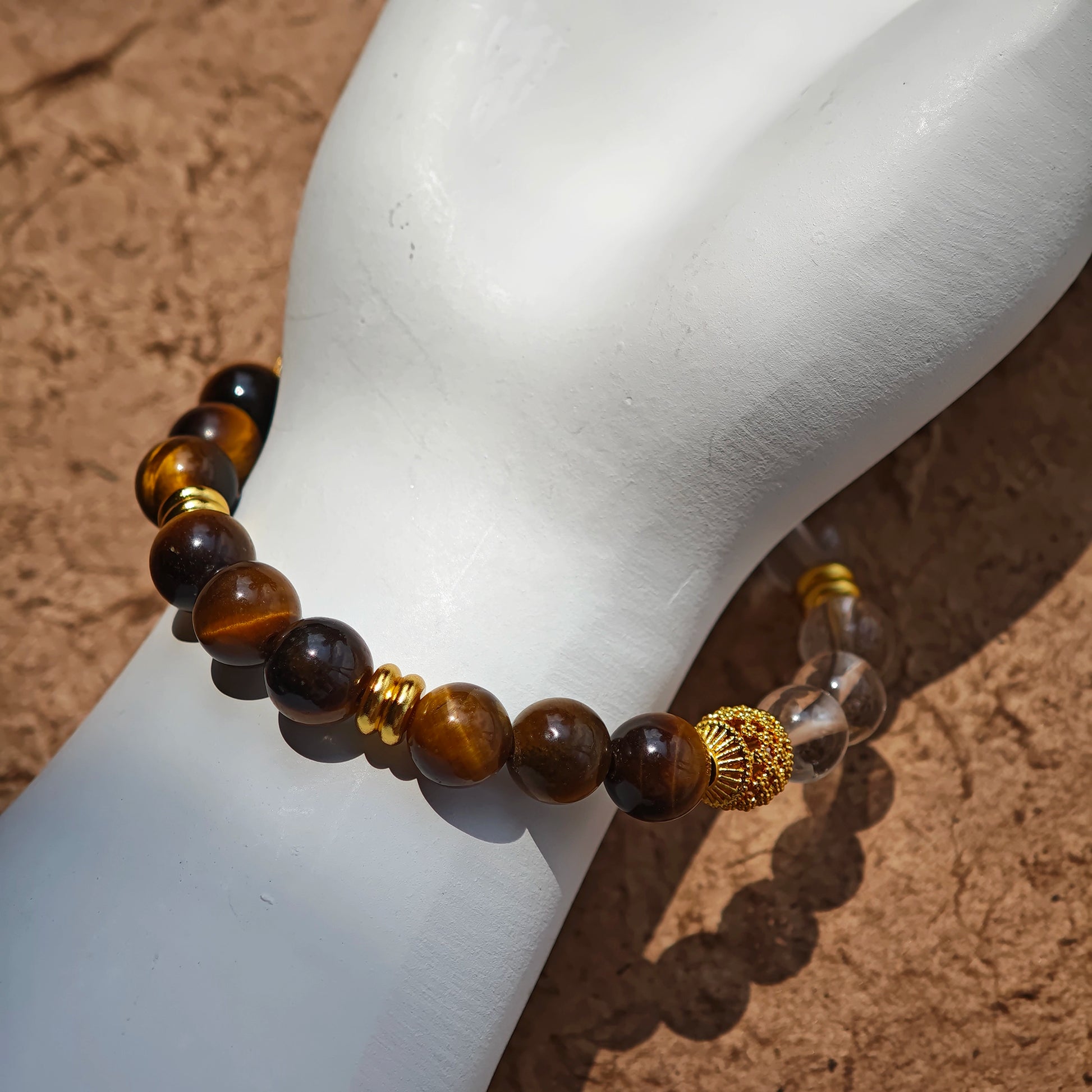 This is a tiger's eye bracelet with clear quartz and gold-plated copper spacer.