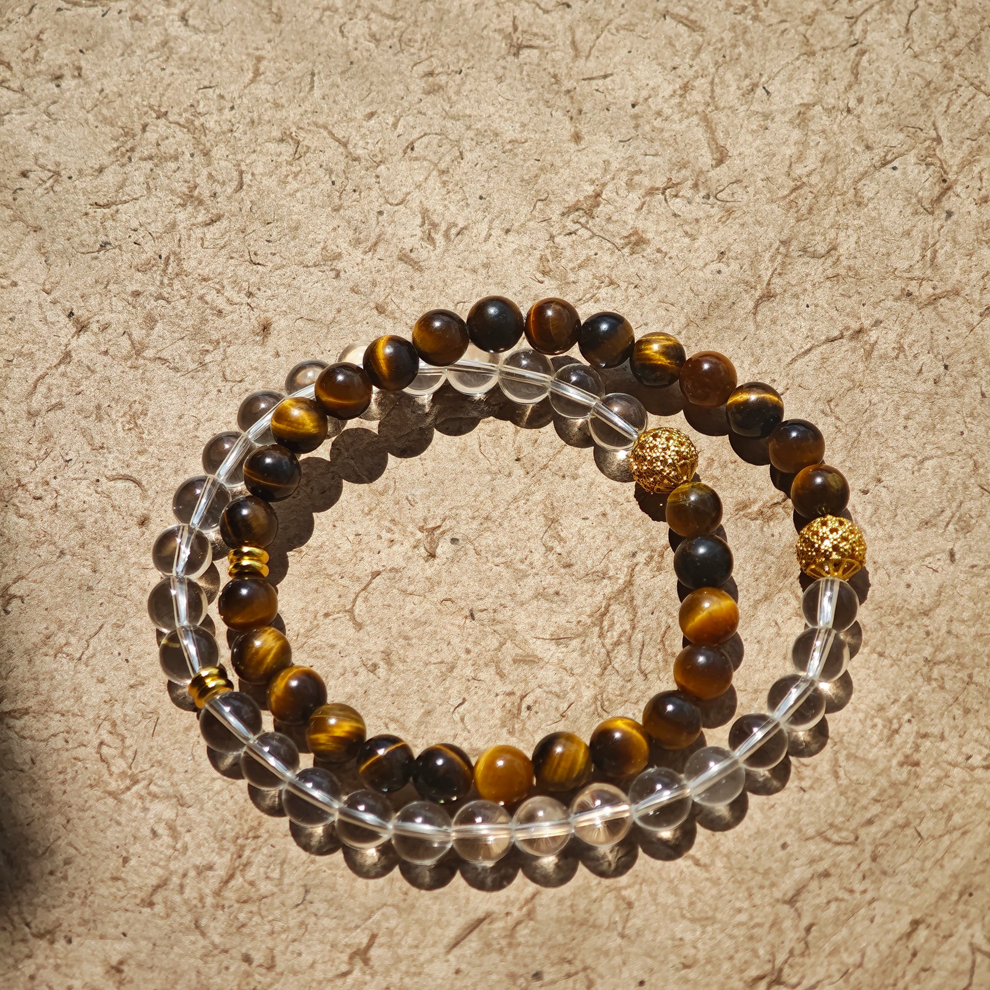 This is a necklace with tiger's eye, clear quartz, gold-plated spacer and elastic cord.