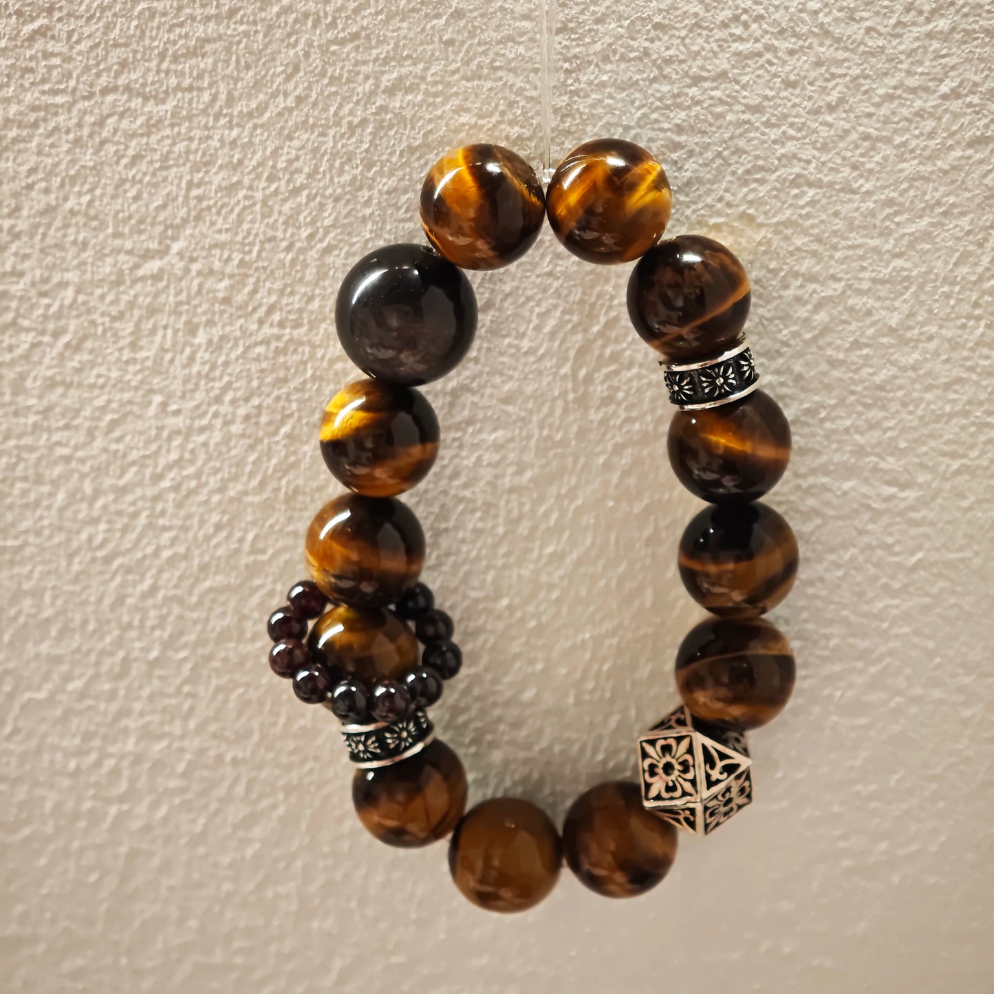 A handmade bracelet with Tiger's Eyes, Silver Sheen Obsidian and Garnet.