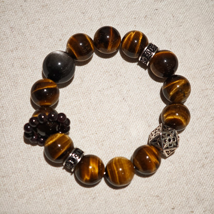 A handmade bracelet with Tiger's Eyes, Silver Sheen Obsidian and Garnet.