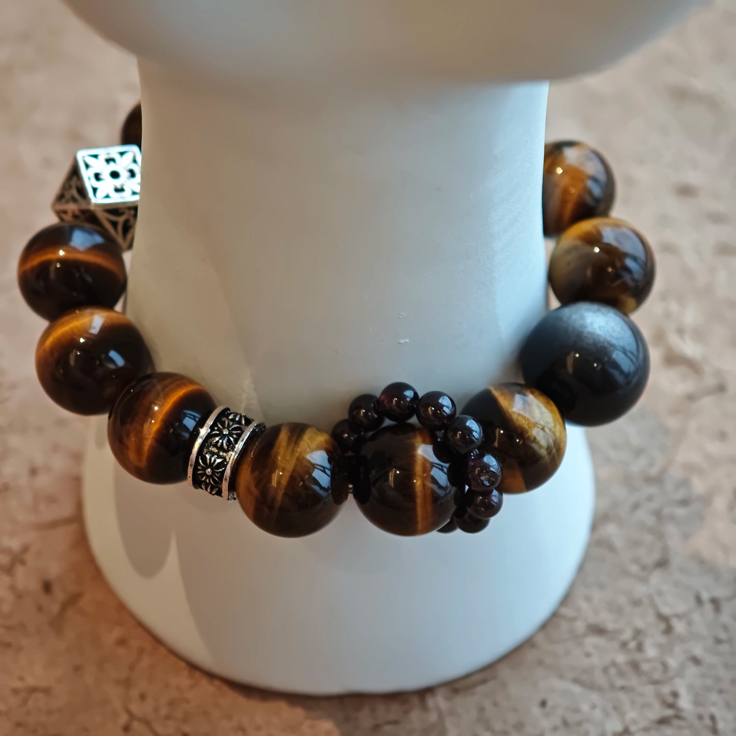 A handmade bracelet with Tiger's Eyes, Silver Sheen Obsidian and Garnet.