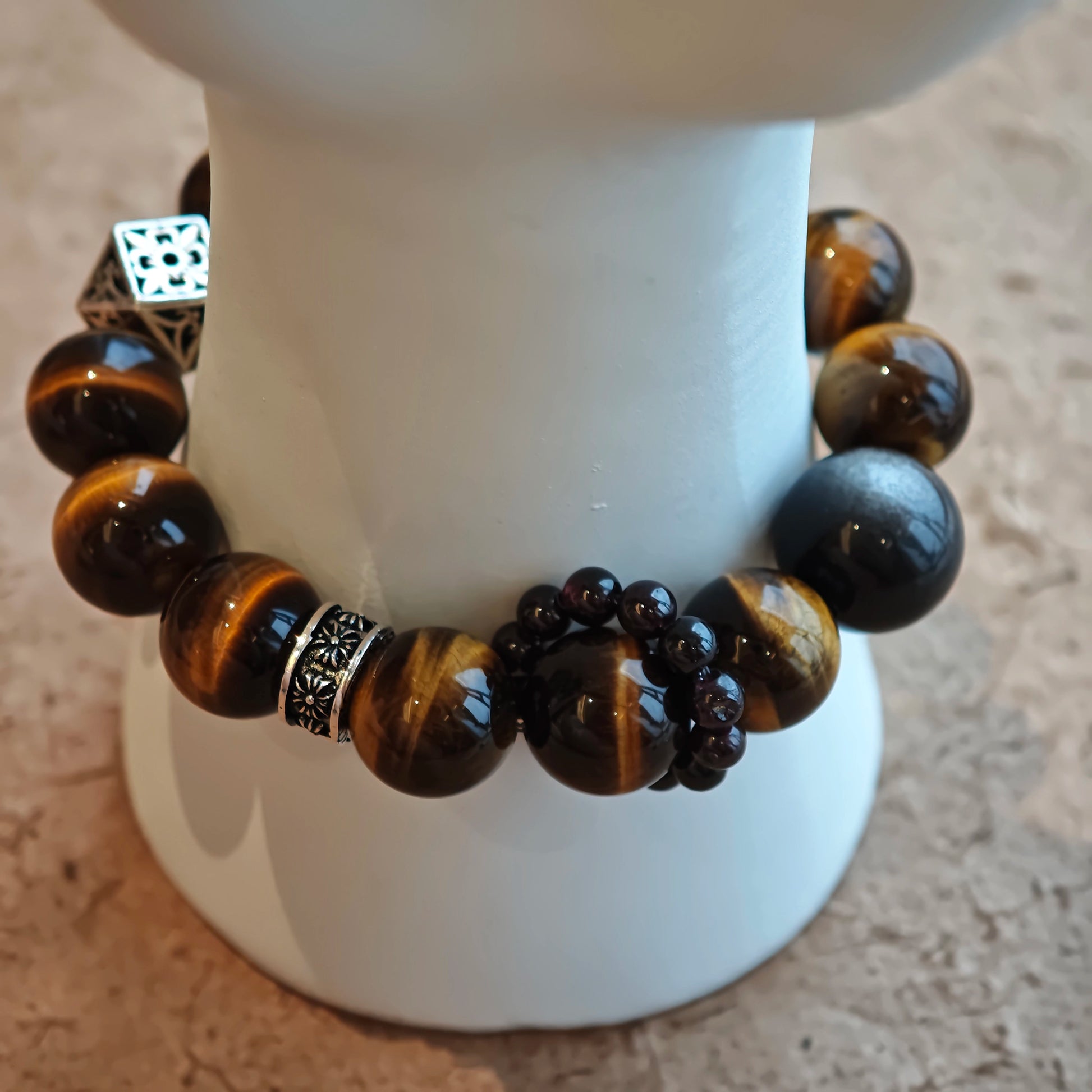 A handmade bracelet with Tiger's Eyes, Silver Sheen Obsidian and Garnet.
