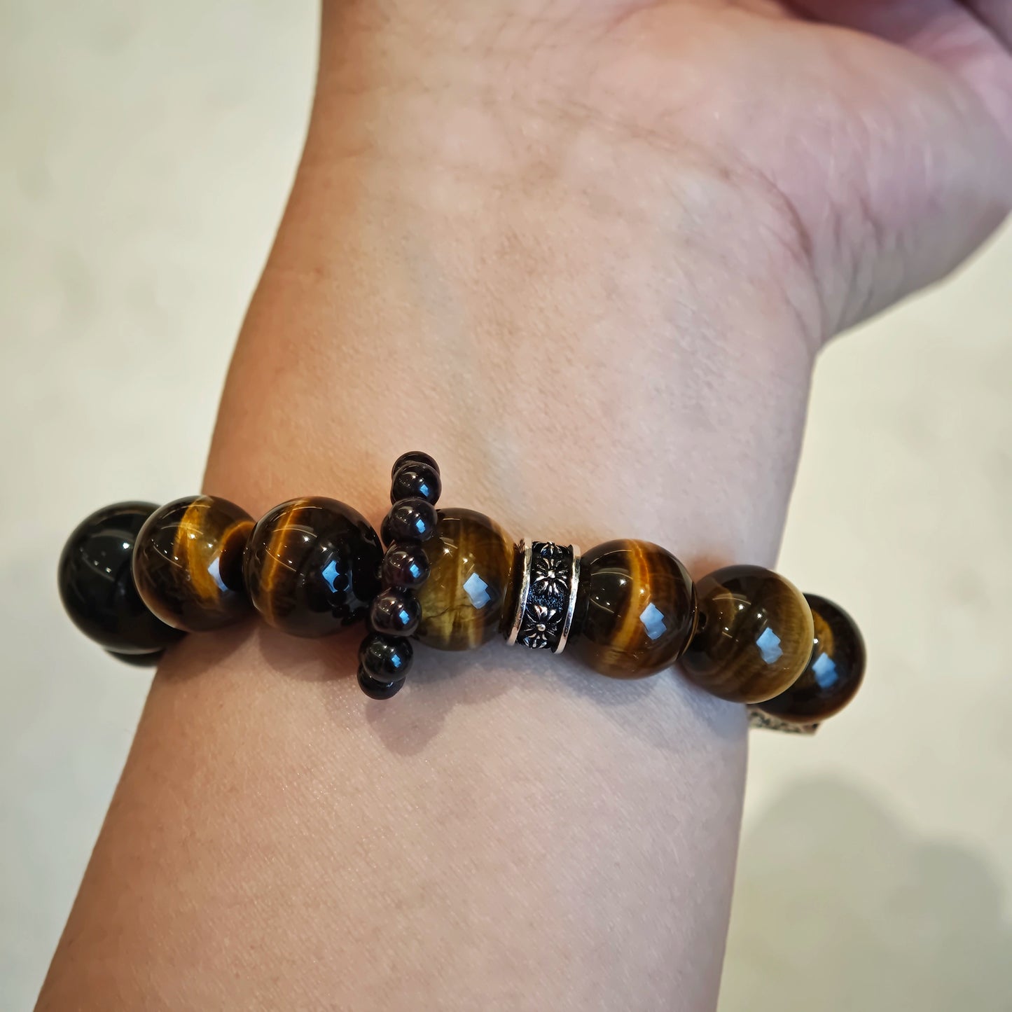 A handmade bracelet with Tiger's Eyes, Silver Sheen Obsidian and Garnet.