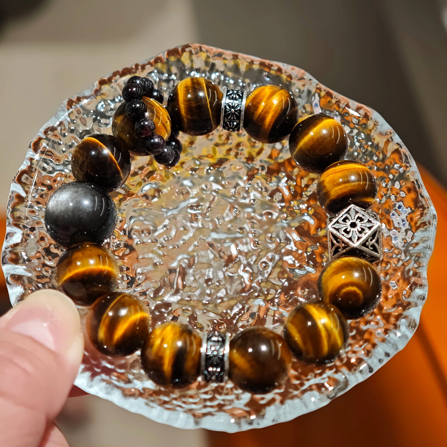 A handmade bracelet with Tiger's Eyes, Silver Sheen Obsidian and Garnet.