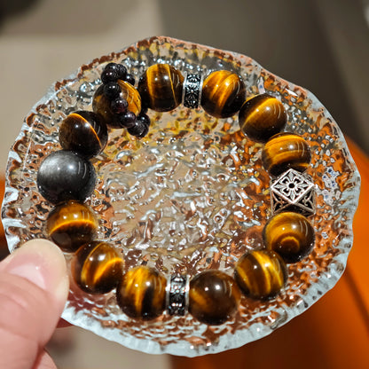 A handmade bracelet with Tiger's Eyes, Silver Sheen Obsidian and Garnet.