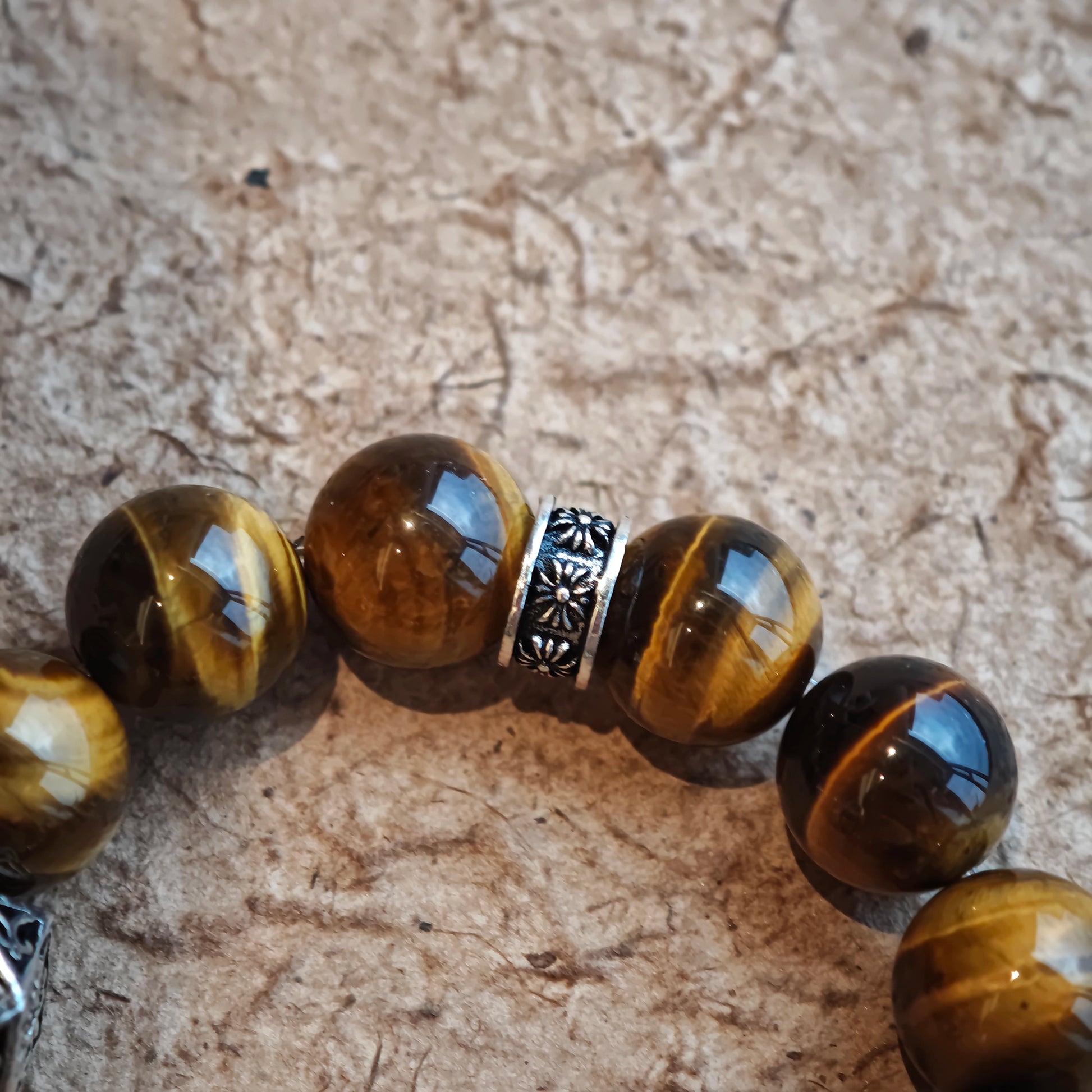 A handmade bracelet with Tiger's Eyes, Silver Sheen Obsidian and Garnet.