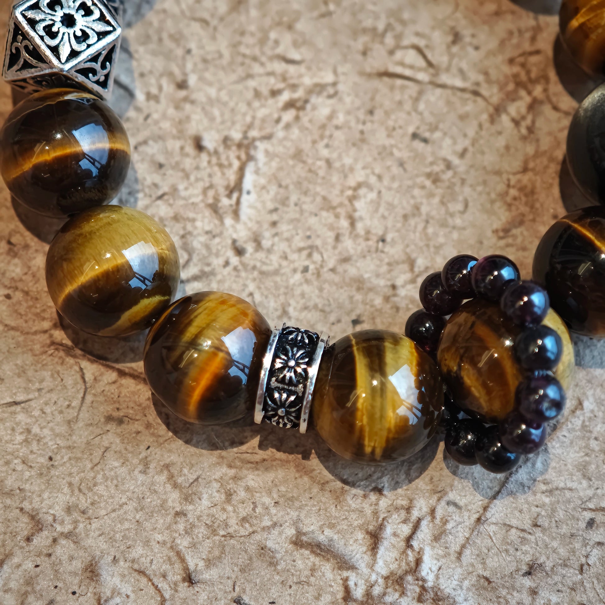 A handmade bracelet with Tiger's Eyes, Silver Sheen Obsidian and Garnet.
