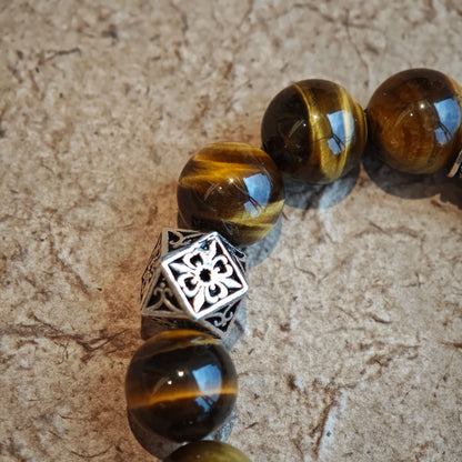 A handmade bracelet with Tiger's Eyes, Silver Sheen Obsidian and Garnet.