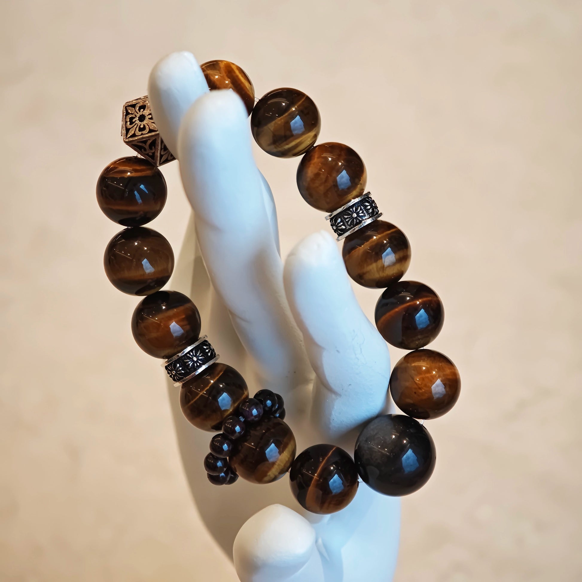 A handmade bracelet with Tiger's Eyes, Silver Sheen Obsidian and Garnet.