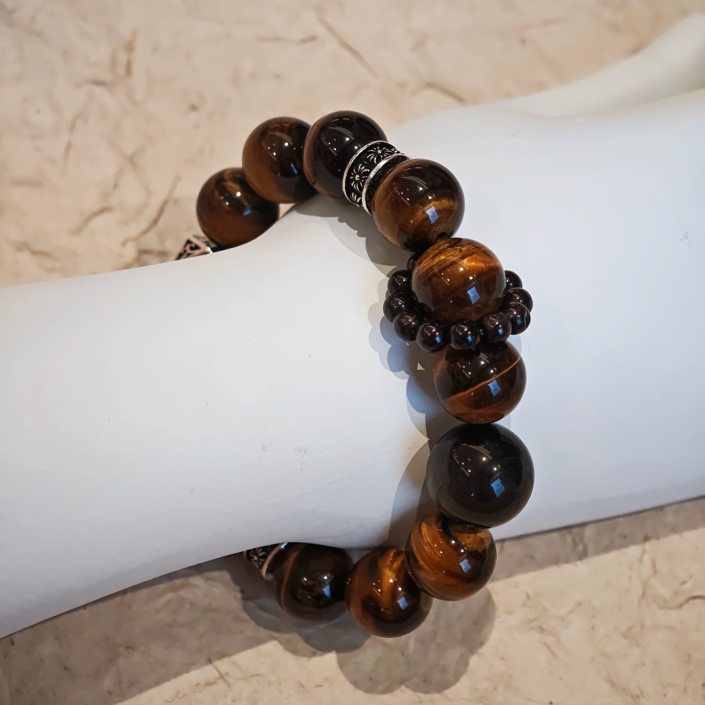 A handmade bracelet with Tiger's Eyes, Silver Sheen Obsidian and Garnet.