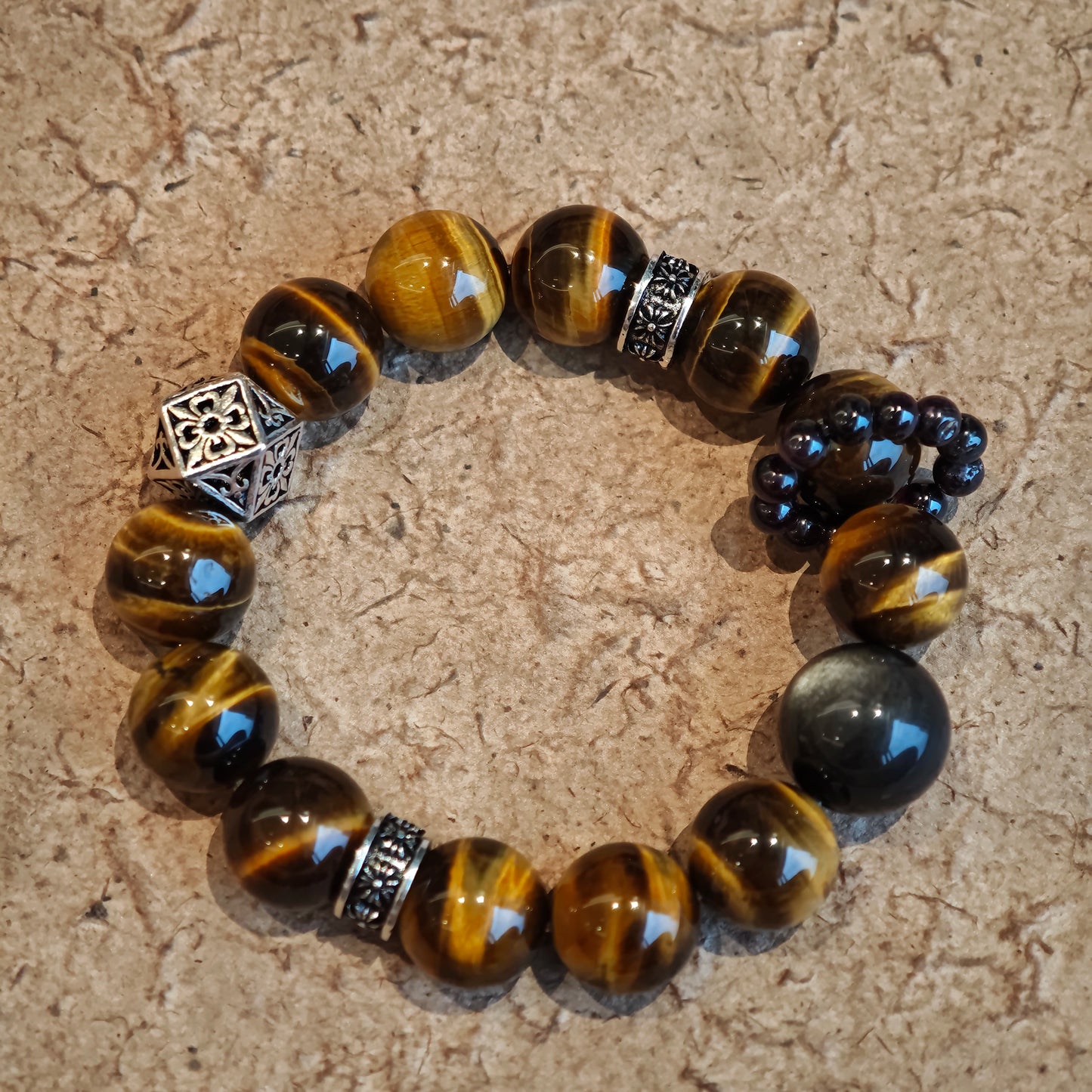 A handmade bracelet with Tiger's Eyes, Silver Sheen Obsidian and Garnet.