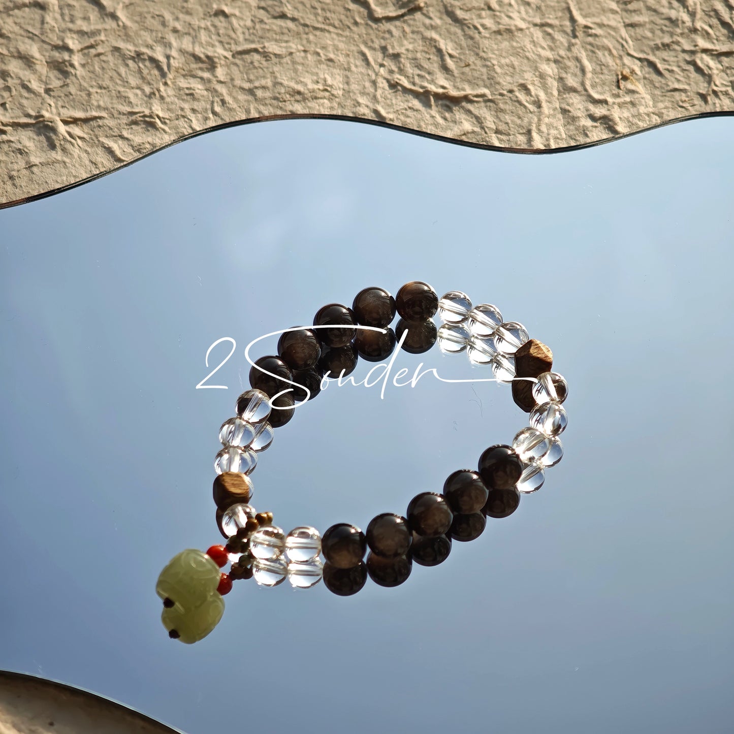 This bracelet combines genuine Silver Obsidian (look for the subtle silver sheen under light), high-clarity White Quartz, and Real Agarwood. Unlike synthetic imitations, our Agarwood carries a faint, natural woody scent that deepens over time. Plus, there is an Agate ring in the bracelet, which adds a touch of classical beauty. It feels grounded and real on your skin.