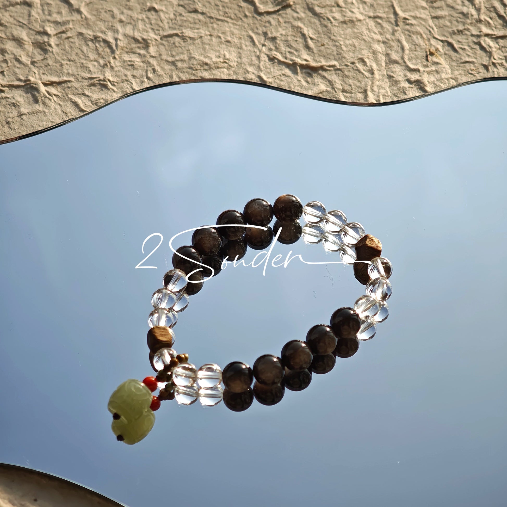 This bracelet combines genuine Silver Obsidian (look for the subtle silver sheen under light), high-clarity White Quartz, and Real Agarwood. Unlike synthetic imitations, our Agarwood carries a faint, natural woody scent that deepens over time. Plus, there is an Agate ring in the bracelet, which adds a touch of classical beauty. It feels grounded and real on your skin.