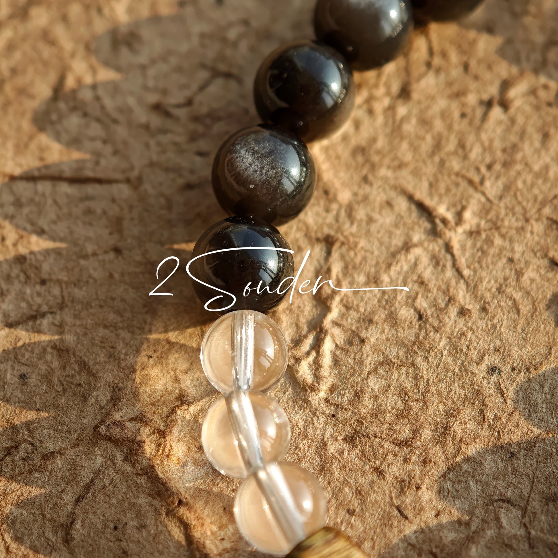 This bracelet combines genuine Silver Obsidian (look for the subtle silver sheen under light), high-clarity White Quartz, and Real Agarwood. Unlike synthetic imitations, our Agarwood carries a faint, natural woody scent that deepens over time. Plus, there is an Agate ring in the bracelet, which adds a touch of classical beauty. It feels grounded and real on your skin.