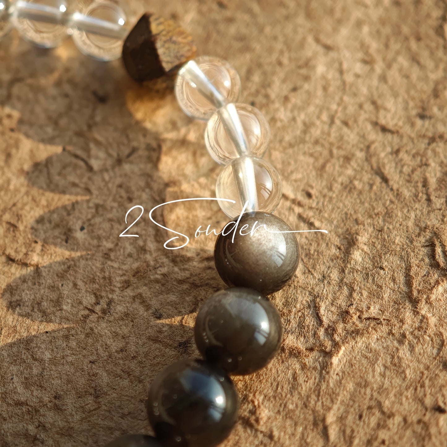 This bracelet combines genuine Silver Obsidian (look for the subtle silver sheen under light), high-clarity White Quartz, and Real Agarwood. Unlike synthetic imitations, our Agarwood carries a faint, natural woody scent that deepens over time. Plus, there is an Agate ring in the bracelet, which adds a touch of classical beauty. It feels grounded and real on your skin.